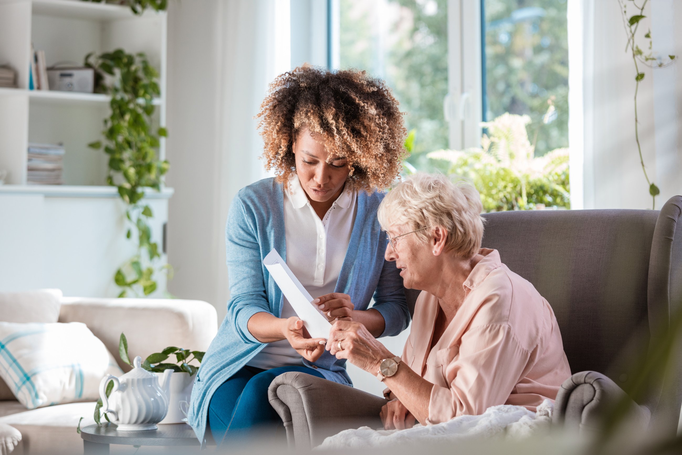 Home nurse taking care of senior woman